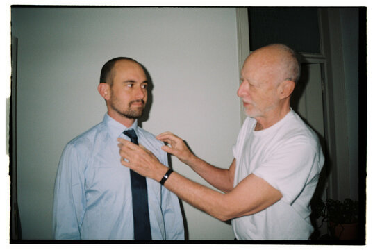 Film portrait with senior father helping son with a tie