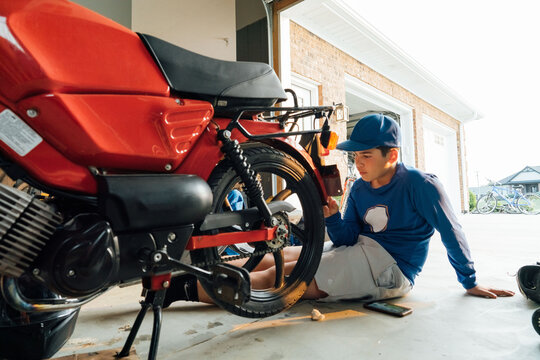 Red moped parked in a garage. 