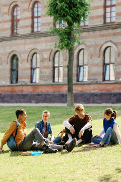 Students enjoying conversations in dormitory backyard