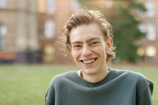 Portrait camera aware generation z laugh facial expression androgyne