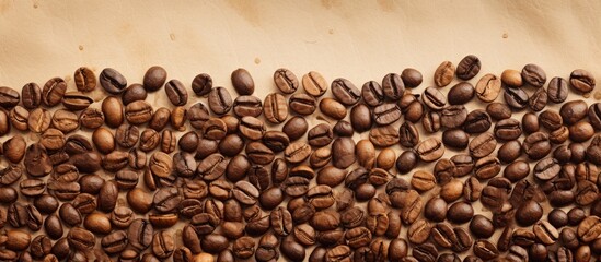 A collection of coffee beans is arranged neatly on top of a wooden table. The beans vary in color, size, and shape, creating an interesting visual display against the tables surface.
