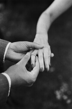 Man Putting Wedding Ring on Woman 