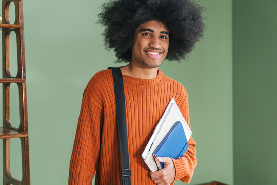man hands putting student stuff into bag
