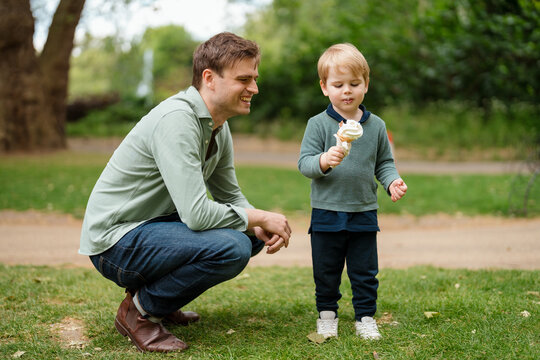 Father bought his son ice cream at the park