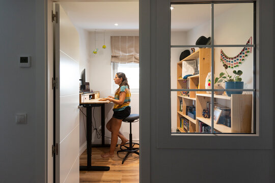 Woman working in standing desk in home office