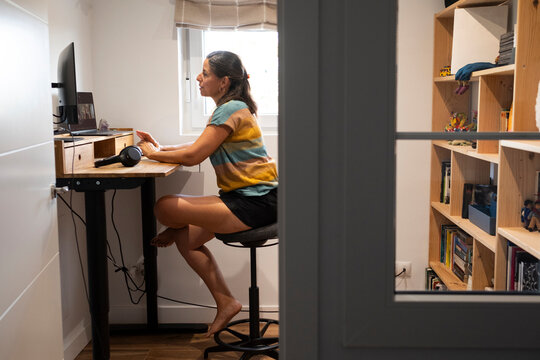 Woman working in standing desk in home office