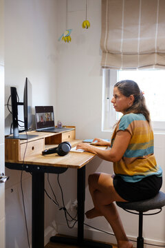 Woman working in standing desk in home office