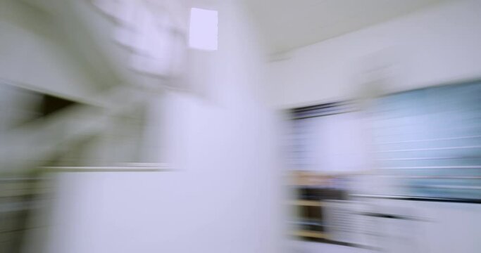 Fast spinning motion blur of white empty living room interior
