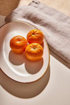 Multiple clementines on a plate