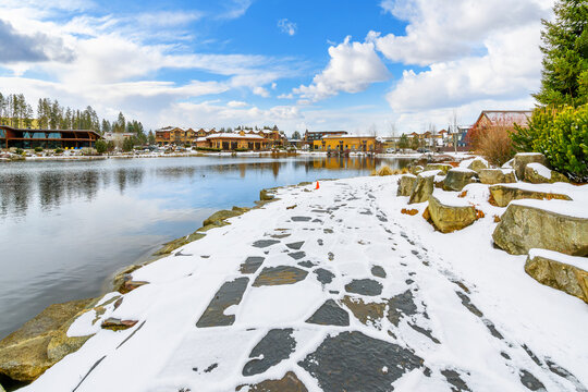 Riverstone public park and lake during winter with snow on the ground, in the Riverstone commercial and residential development in downtown Coeur d'Alene, Idaho, USA	