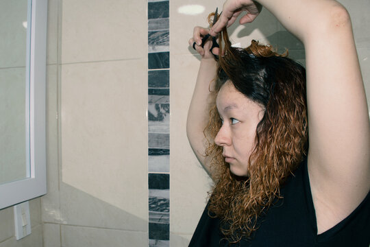 Woman cutting her hair