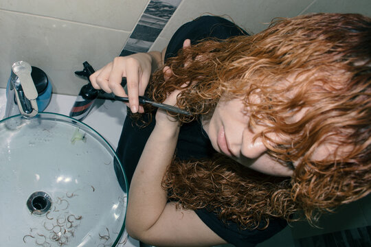 Woman cutting her hair