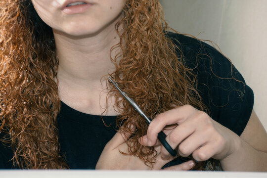 Woman cutting her hair