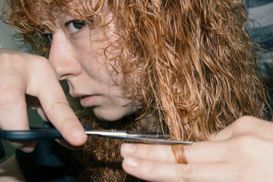 Woman cutting her hair