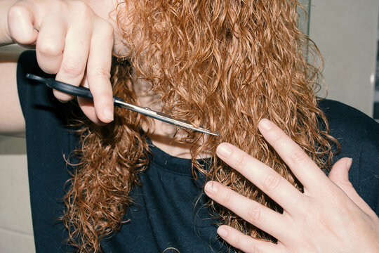 Woman cutting her hair