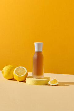 Simple Syrup in a glass bottle with fresh lemon on yellow background