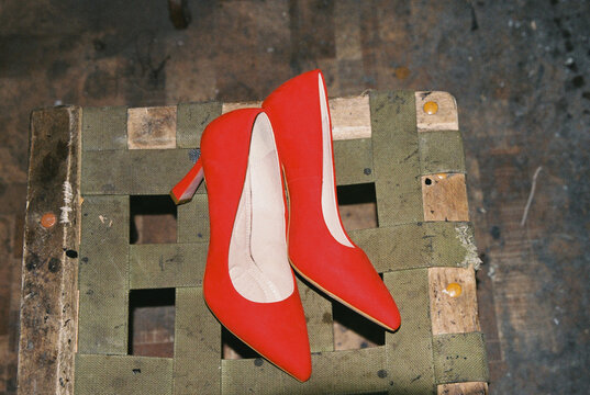 Red shoes after being repaired in a shoe repair shop 