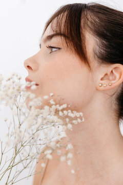 Young woman with white gypsophila
