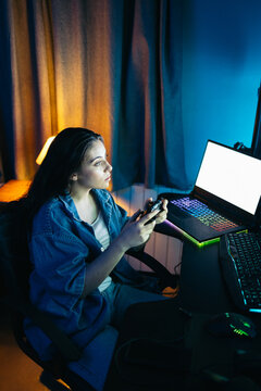 Gamer girl having fun playing video game on computer