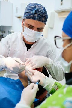Dentists working with a patient