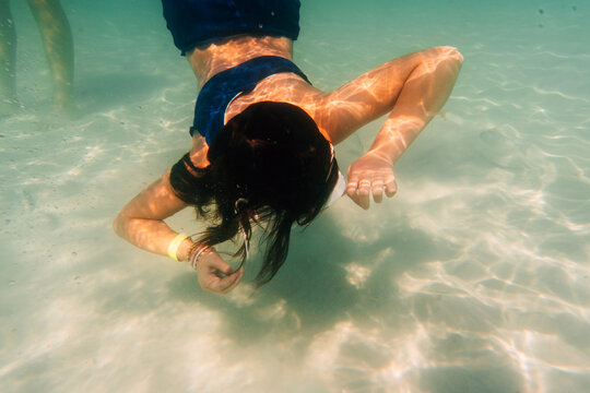 Underwater swimmer along the ocean bottom.