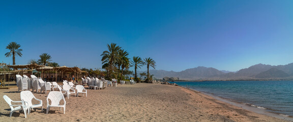 Panorama. View on the Red Sea from a sandy beach in Eilat - famous tourist resort and recreational city in Israel- 751146604