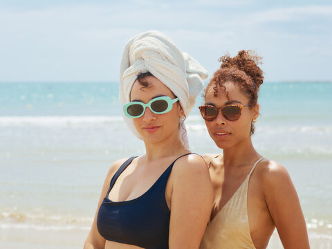 Two women friends go on vacation together at seaside destination      