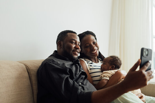 Family with Newborn Baby on Video Call