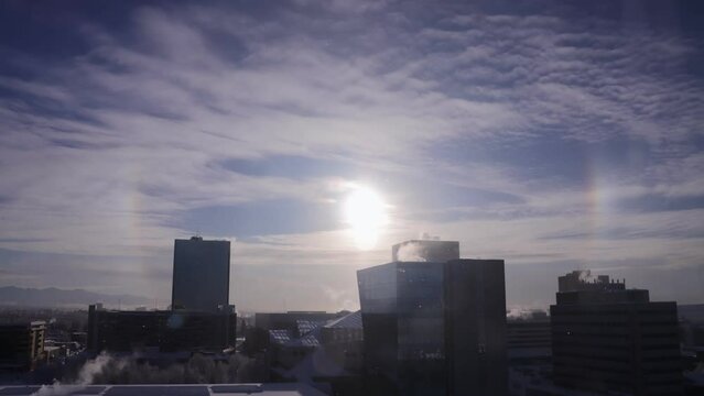 Parhelion Sun Dogs forming in freezing conditions over Anchorage Skyline, time lapse