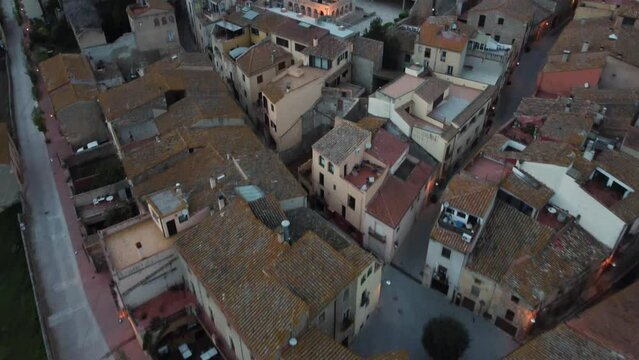 Aerial View Flying Over Rooftops In The City Of Peralada In Girona Costa Brava Towards Sant Mart&iacute; Church. Descending Shot, Push Forward 