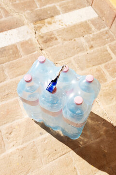 Plastic package of clear hydrating blue plastic water bottles