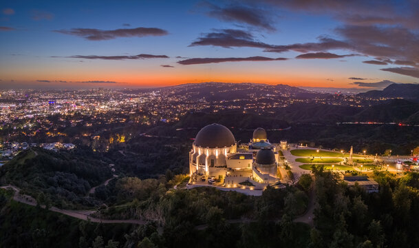 Griffith Observatory and city of Los Angeles skyline panorama at dusk. Aerial view.