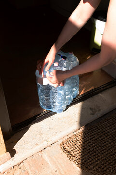 Plastic package of clear hydrating blue plastic water bottles