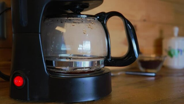 Coffee maker with boiling and dripping sound starting to make coffee.
