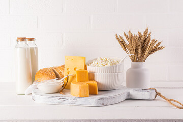 festive still life for the Jewish holiday of Shavuot. Several types of cheese, bottled milk,...