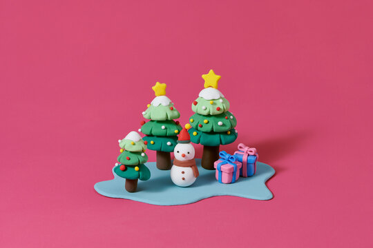  Green Christmas tree with star and box of gifts strewn with snow