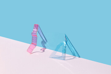 Bent pink and transparent ruler and triangle.