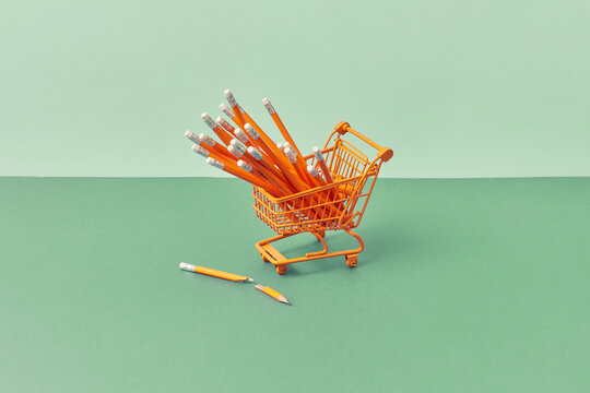 Shopping cart with pencils, one broken beside.
