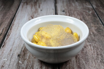 Bird Nest with Ginkgo Nuts and lotus root serving with syrup in the bowl. Famous sweet dessert in Chinese restaurant. Luxury snack menu in Asia.