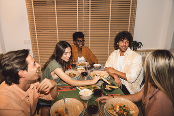 Diverse Friends Having Dinner at home While chatting