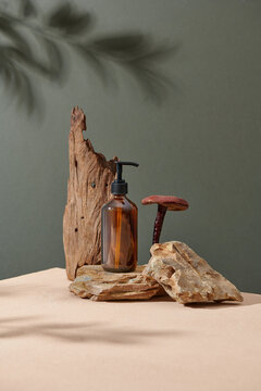 Amber glass shampoo bottle on wooden and stone podium.
