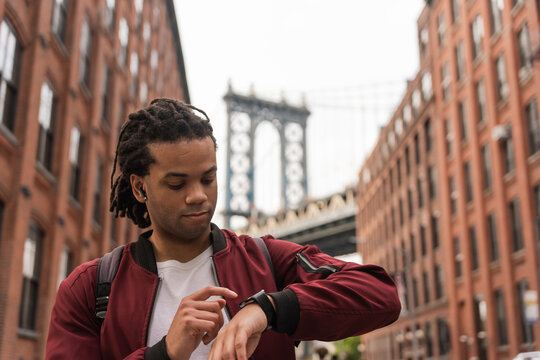 Black Man Checking His Watch On The Streets Of New York.