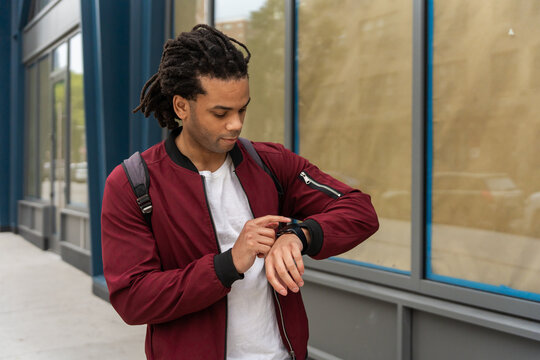 Black Man Checking His Watch On The Streets Of New York.