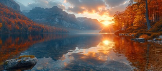 Fototapeta na wymiar Fantastic panorama of lake at beautiful autumn sunset in mountains