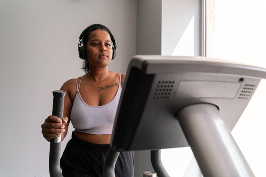 Curvy Indian Woman Using Elliptical Trainer 