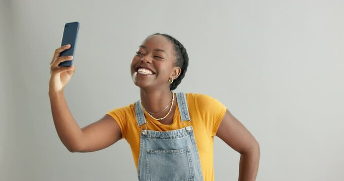 Studio, smile or black woman in a selfie on social media with confidence, post or mobile app. African person, isolated or influencer taking a photograph, vlog or picture online on grey background