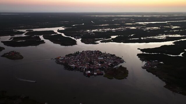 Drone shot tilting toward the Mexcaltitan town, vibrant dusk in Nayarit, Mexico