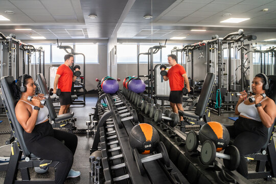 People Working Out With Weights In The Gym
