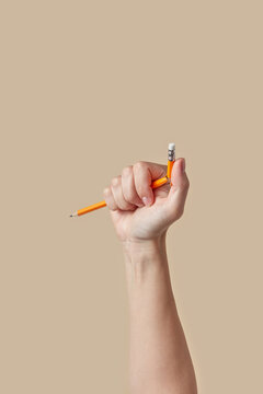 Female hand breaking graphite pencil.