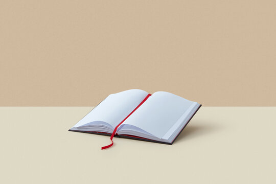Open blank book with red bookmark.